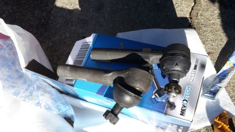 1980 Ford Mustang - Automotive steering and suspension parts are laid out on a surface, with packaging visible.