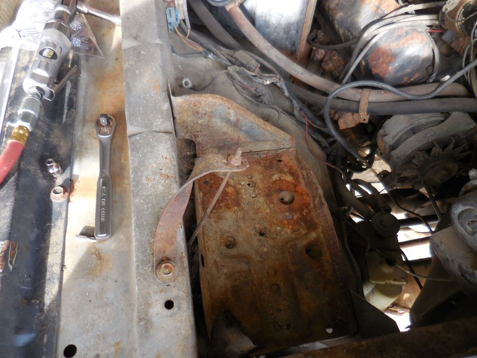 Ratchet and air tool in a rusty engine bay