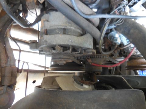 1979 Ford Bronco - Close-up view of an engine's alternator, fan, and associated wiring.