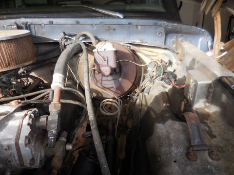 1979 Ford Bronco - View of the engine bay, showing the brake booster, air filter, and various hoses and wires.