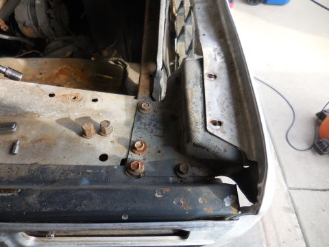 1979 Ford Bronco - Rusty fender mounting bracket with bolts visible, part of a vehicle's front end.