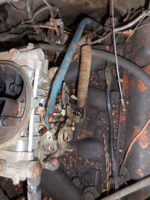 1979 Ford Bronco - The intricate linkage system of a vehicle's carburetor is shown in this detailed close-up.