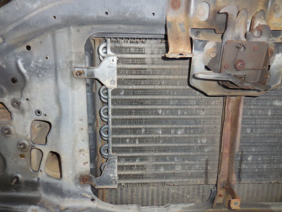 Radiator and hood latch mechanism