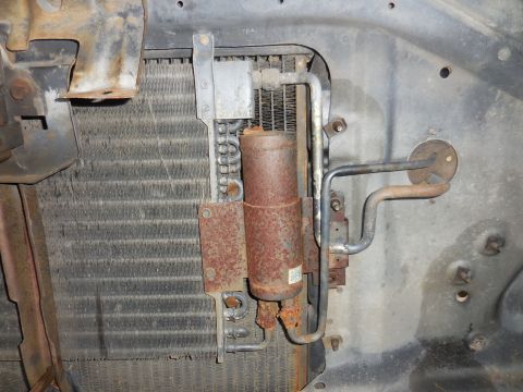 1979 Ford Bronco - Close-up of a vehicle's radiator and AC condenser, showing signs of rust.