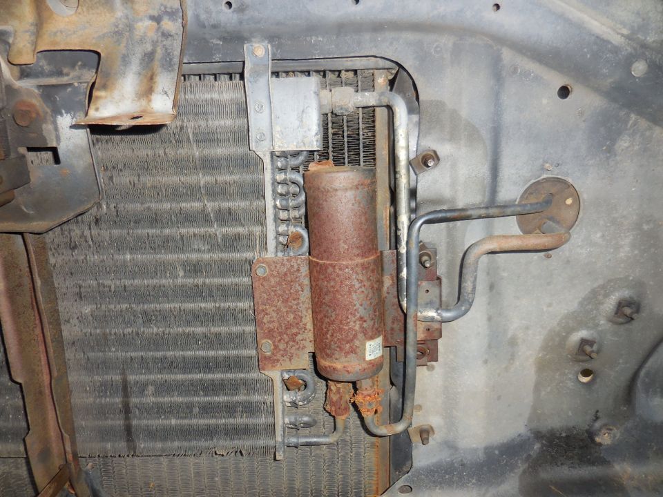 Radiator and AC condenser assembly with rusty lines and canister