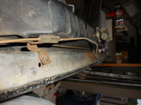 1979 Ford Bronco - Close-up view of a vehicle's rusty frame and radiator components.