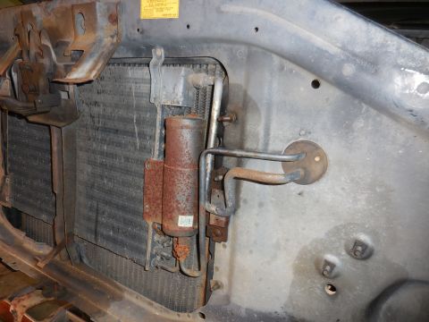 1979 Ford Bronco - Close-up of the radiator and AC receiver-drier assembly, showing signs of rust and wear.