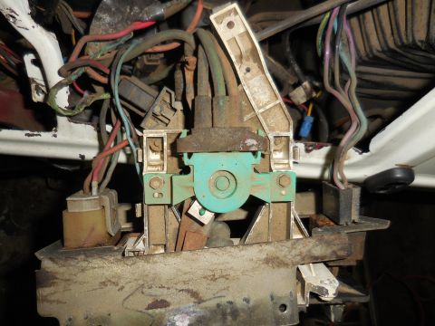 1979 Ford Bronco - A close-up view of a complex automotive electrical wiring harness with multiple colored wires, connectors, and a teal-colored component, al…