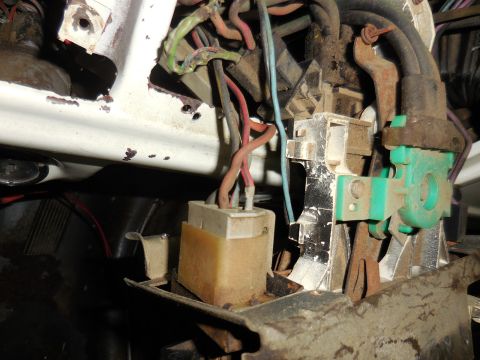 1979 Ford Bronco - This is a close-up view of the wiring harness and electrical components under the dashboard of a 1979 Ford Bronco. The image shows various…