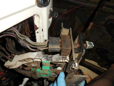 1979 Ford Bronco - Close-up view of the steering column wiring harness and ignition switch assembly of a vintage Ford Bronco. The image shows various colored…