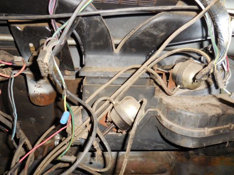 1979 Ford Bronco - This image shows a close-up view of the interior wiring harness and components of a 1979 Ford Bronco. The focus is on the dashboard area, w…