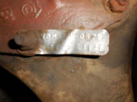 1979 Ford Bronco - A close-up view of a metal stamping on a rusty, reddish-brown metal part. The stamping reads "YOM-GJ 0829" on the top line and "275 S3148"…