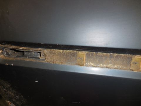 1979 Ford Bronco - Interior door latch mechanism showing wear and dust accumulation.