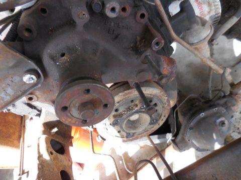 1979 Ford Bronco - This is an underside view of a heavily rusted engine bay, showing the crankshaft pulley and part of the engine block. A Ford oil filter is…