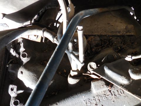 1979 Ford Bronco - This is a close-up view of the engine bay of a 1979 Ford Bronco, showing various hoses, engine components, and some surface rust. The image…