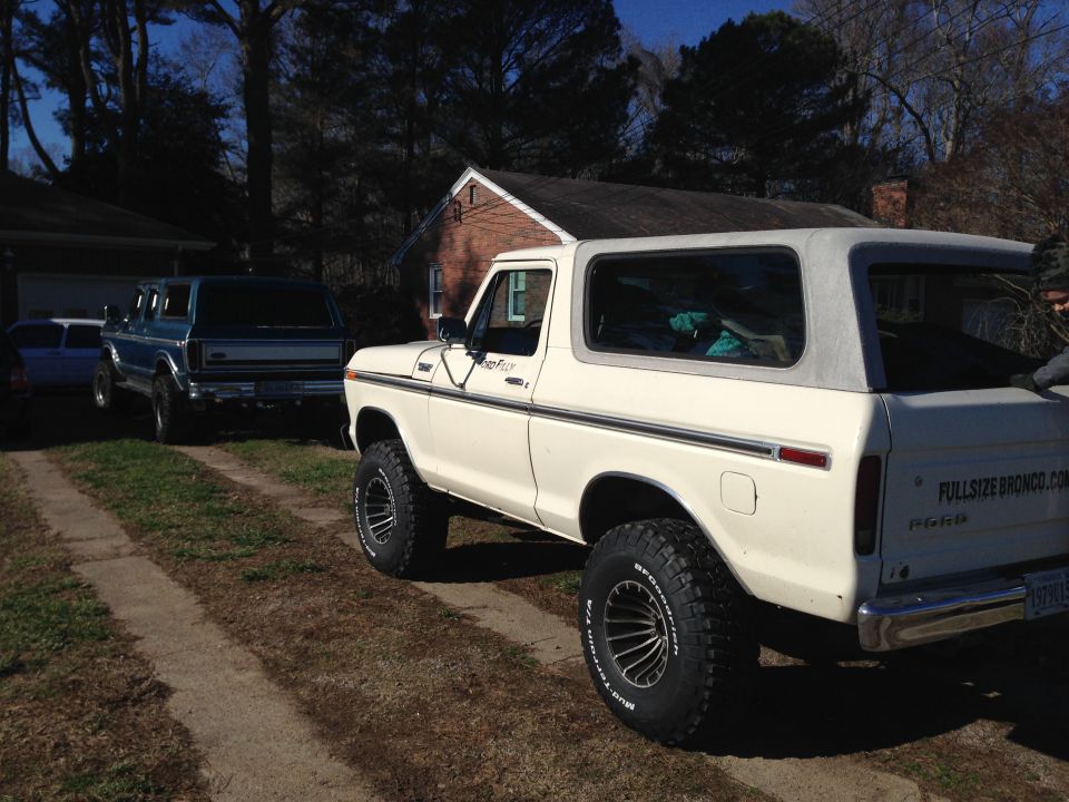 White 1979 Ford Bronco parked on a dirt driveway.