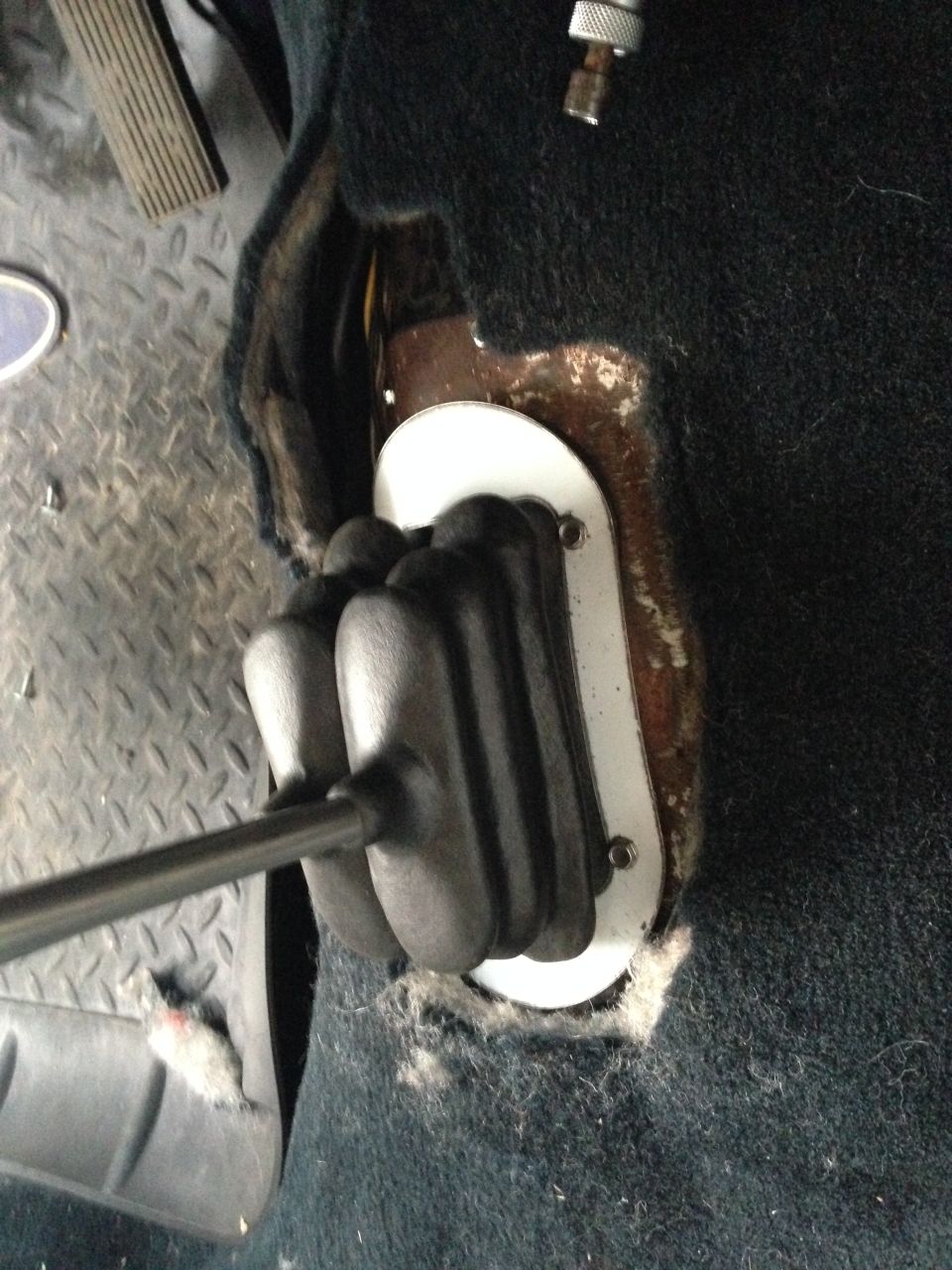 Close-up of a gear shifter boot and lever in a vehicle interior.