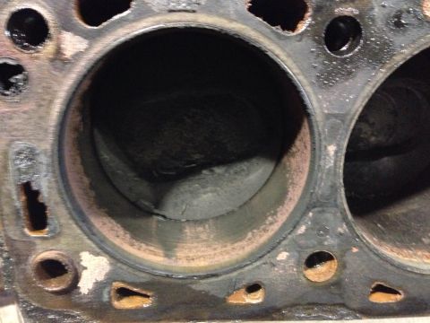 1979 Ford Bronco - Close-up of damaged engine block cylinders with visible rust and wear.