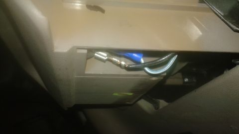 1996 Ford Bronco - A close-up view shows electrical wiring with a blue connector and a silver crimp connector attached to a black wire and a lighter colored w…