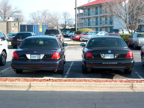 2001 Ford Crown Victoria - Two Ford sedans, a Marauder and a Crown Victoria, are parked side-by-side in a parking lot.