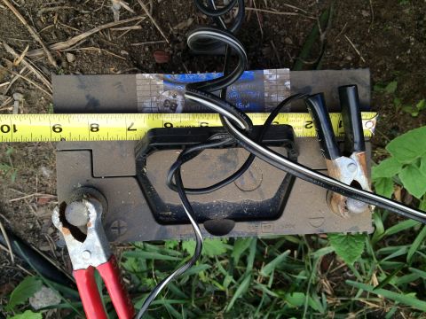 1987 Suzuki Samurai - Photograph of a vehicle battery being measured with a tape measure, not a technical document.