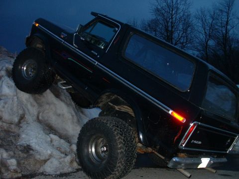 1978 Ford Bronco - This 1978 Ford Bronco is shown climbing a snow bank, demonstrating its off-road capabilities.