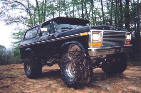 1978 Ford Bronco - Modified 1978 Ford Bronco with lifted suspension and aggressive tires sits off-road.