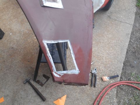 1972 Ford Bronco - A close-up view of a car door or panel being worked on, with a cut-out section showing fresh welds. Tools like a hammer, pliers, and a weld…