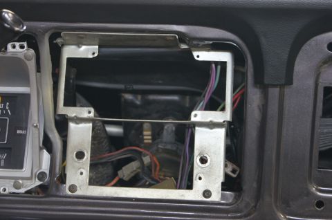 1979 Ford Bronco - This is a close-up view of the dashboard of a 1979 Ford Bronco, showing the area around the radio and instrument cluster with wiring expose…