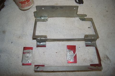 1979 Ford Bronco - Several pieces of metal with red layout fluid are laid out on a white cloth surface. The pieces appear to be parts of a larger assembly, po…