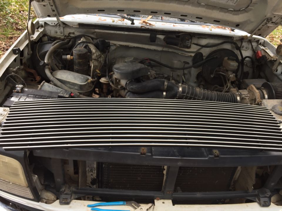 1996 Ford Bronco engine bay with custom chrome grille