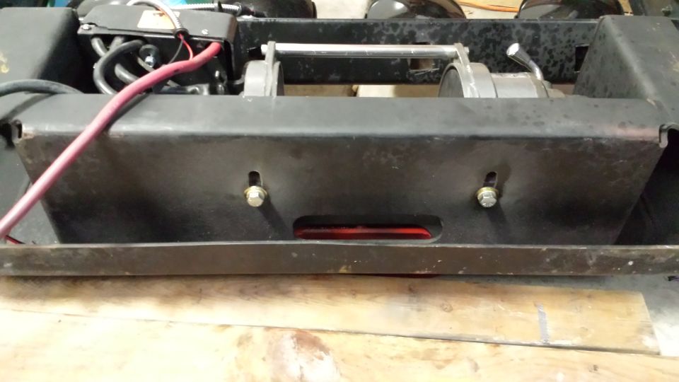 Winch assembly with red cable on black bracket