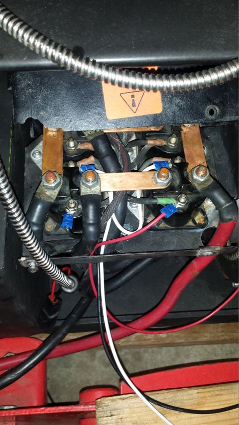 1996 Ford Bronco - Close-up view of heavy-duty electrical connections, likely for a starter or battery system, featuring thick black cables, copper bus bars,…