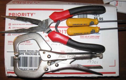 2000 Ford Crown Victoria - A collection of tools, including needle-nose pliers, a pair of diagonal cutters, locking pliers, and two small screwdrivers, are laid out o…