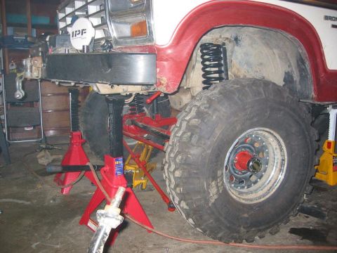 1985 Ford Bronco - This 1985 Ford Bronco is shown with its front end elevated on jack stands, highlighting its large off-road tires and suspension modificatio…