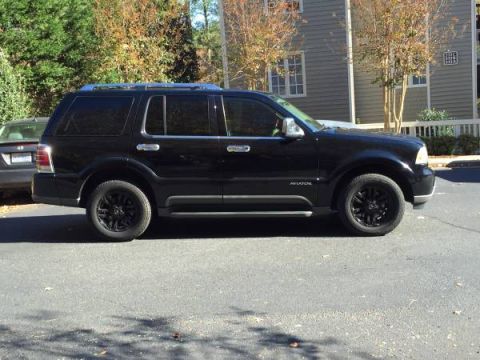 2003 Lincoln Aviator - Side view of a black 2003 Lincoln Aviator SUV with aftermarket black wheels.