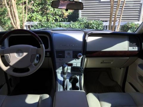 2003 Lincoln Aviator - The interior of a Lincoln Aviator features wood trim and a prominent dashboard display.