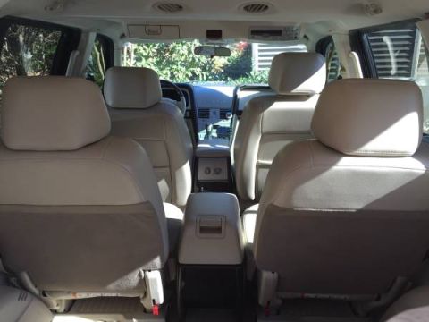 2003 Lincoln Aviator - The interior of a 2003 Lincoln Aviator is captured from the rear seats, looking forward towards the dashboard.