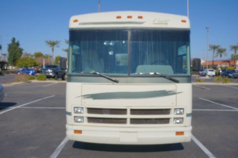 1995 Chevrolet P30 1 Ton - Step Van - Front view of a white RV, identified as a 1995 Chevrolet P30 1 Ton - Step Van, with a distinctive green stripe on its front.