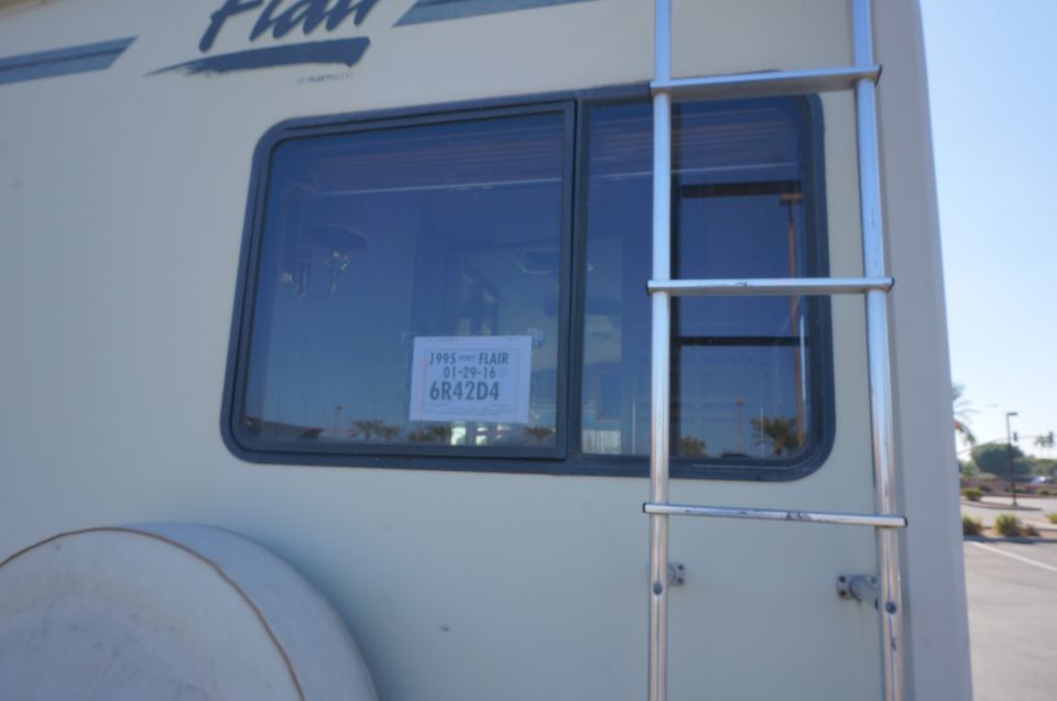 Fleetwood Flair motorhome rear window with chrome ladder and registration card