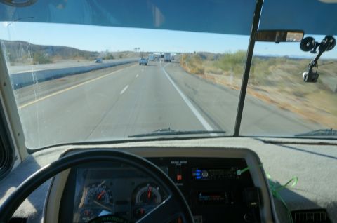 1995 Chevrolet P30 1 Ton - Step Van - Driving on a highway with a clear blue sky and desert landscape visible outside the vehicle.