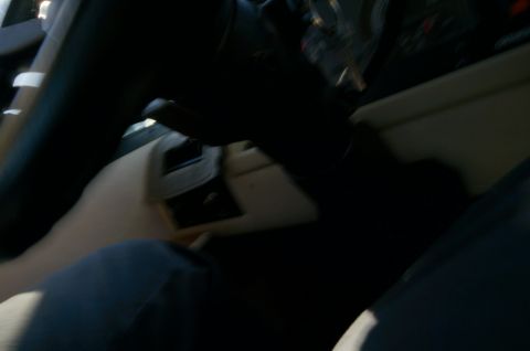 1995 Chevrolet P30 1 Ton - Step Van - Interior view of a vehicle, showing the steering column, dashboard area, and a person's legs in the foreground. The vehicle appears to be a…