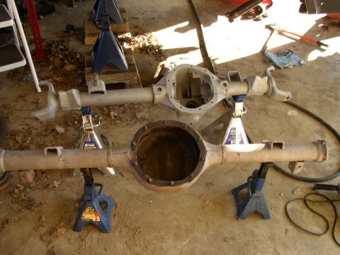 1995 Ford Bronco - Two differential housings are shown on jack stands, one appears to be a replacement part.