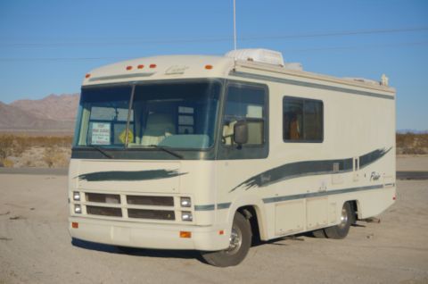 1995 Chevrolet P30 1 Ton - Step Van - A beige and dark green 1995 Chevrolet P30 Step Van, nicknamed "Flair 22D", is parked in a dirt lot with mountains and a clear blue sky in t…
