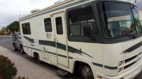 1995 Chevrolet P30 1 Ton - Step Van - A side view of a white and green 1995 Chevrolet P30 step van, nicknamed "Flair 22D", parked on a residential street next to a silver Jeep W…