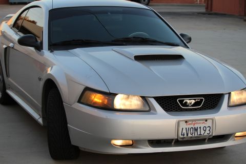 2002 Ford Mustang - The front quarter view of a silver Ford Mustang shows its headlights, grille with a running horse emblem, and a California license plate re…