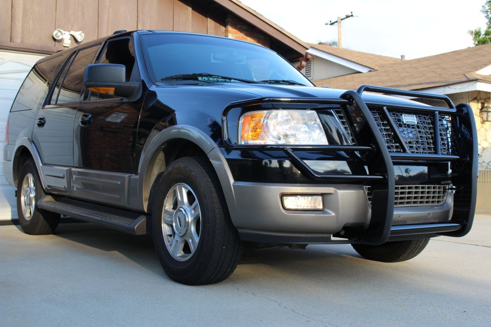 Black 2003 Ford Expedition with bull bar, parked in driveway.