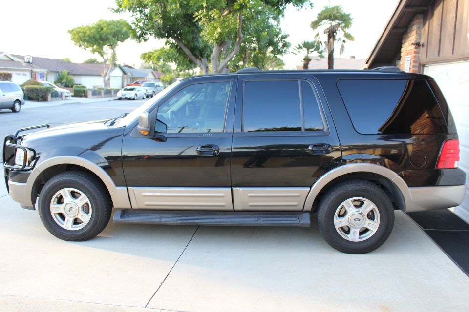 Black 2003 Ford Expedition SUV parked on a driveway.