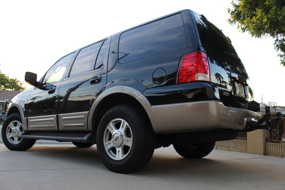 Black 2003 Ford Expedition SUV, rear passenger side view, two-tone paint, chrome wheels