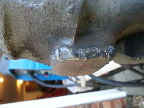 1994 Ford Bronco - A close-up view shows a welded repair on a cast metal vehicle part, possibly a differential housing or transmission casing. The weld appear…